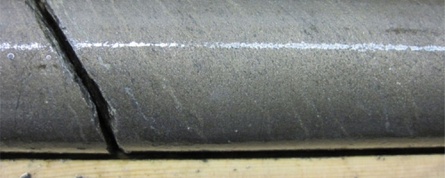 Massive nickel-copper-PGE bearing sulphides in hole GR-14-17 at Grasset; the lighter streaks are comprised mainly of pentlandite indicating post-formation deformation and remobilization of sulphides in the hole 17 area